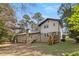 View of home's exterior and backyard showcasing multiple decks and mature trees at 2542 Maclaren Cir, Dunwoody, GA 30360