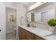 Bathroom featuring a large mirror, wood vanity and a window for natural light at 2542 Maclaren Cir, Dunwoody, GA 30360