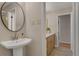 Hallway view to the updated bathroom with a pedestal sink and a wood vanity at 2542 Maclaren Cir, Dunwoody, GA 30360