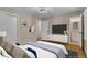 Staged bedroom with modern decor, stylish furniture, and an en-suite bathroom at 2542 Maclaren Cir, Dunwoody, GA 30360