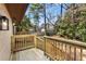 View of home's backyard from the deck with wood railing and stairs at 2542 Maclaren Cir, Dunwoody, GA 30360