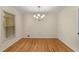 Well-lit dining room with hardwood floors and a modern chandelier, perfect for Gathering meals and entertaining guests at 2542 Maclaren Cir, Dunwoody, GA 30360