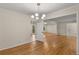 Charming dining room with hardwood floors and a chandelier, seamlessly connected to other living spaces at 2542 Maclaren Cir, Dunwoody, GA 30360