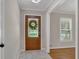 Entryway with marble floors, view of a window, and detailed glass in the wooden door at 2542 Maclaren Cir, Dunwoody, GA 30360