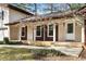 Inviting front porch with charming brown shutters accents the home's classic appeal and curb appeal at 2542 Maclaren Cir, Dunwoody, GA 30360