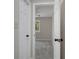 Hallway view leading to a serene bedroom featuring a ceiling fan and a bright window at 2542 Maclaren Cir, Dunwoody, GA 30360