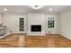 Open-concept living room featuring a fireplace and easy access to the kitchen and exterior areas at 2542 Maclaren Cir, Dunwoody, GA 30360