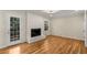 Bright living room featuring hardwood floors, fireplace and a door to the exterior at 2542 Maclaren Cir, Dunwoody, GA 30360