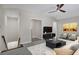 Staged living room features contemporary furnishings, ceiling fan, and access to upstairs via adjacent staircase at 2542 Maclaren Cir, Dunwoody, GA 30360