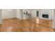 Open floor plan with hardwood floors connecting a living room, kitchen, and dining area at 2542 Maclaren Cir, Dunwoody, GA 30360