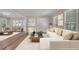 Bright living room with hardwood floors and large windows, staged with modern furniture at 2542 Maclaren Cir, Dunwoody, GA 30360