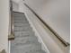 Carpeted staircase with a wooden handrail ascending to the upper level of the home at 2542 Maclaren Cir, Dunwoody, GA 30360