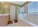 Serene main bathroom featuring a large soaking tub and glass-enclosed shower at 5760 Stephens Mill Dr, Sugar Hill, GA 30518