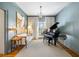 Elegant living room with piano, a modern chandelier and an eye-catching art piece at 6785 Wright Ne Rd, Atlanta, GA 30328