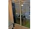 Patio doors leading to a balcony featuring artificial turf and outdoor seating, showcasing indoor-outdoor living at 795 Hammond Dr # 813, Sandy Springs, GA 30328