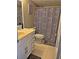 Clean bathroom with a white vanity, decorative shower curtain, and tiled flooring at 795 Hammond Dr # 813, Sandy Springs, GA 30328