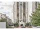 Exterior view of a high-rise building with a covered entry and surrounding landscaped grounds at 795 Hammond Dr # 813, Sandy Springs, GA 30328