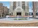 Exterior view of a high-rise building with a fountain in front of the Park Towers entrance at 795 Hammond Dr # 813, Sandy Springs, GA 30328