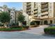 Exterior view of a high-rise building with manicured landscaping at the entrance at 795 Hammond Dr # 813, Sandy Springs, GA 30328