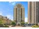 Residential tower building with a circular driveway and verdant trees in front at 795 Hammond Dr # 813, Sandy Springs, GA 30328