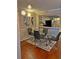 Modern dining room with glass table, hardwood floors, and adjacent kitchen at 795 Hammond Dr # 813, Sandy Springs, GA 30328