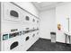 Bright laundry room featuring multiple rows of commercial-grade washing machines for resident use at 795 Hammond Dr # 813, Sandy Springs, GA 30328