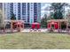 Beautifully landscaped outdoor area with lounge area, fire pit, and grill by high-rise at 795 Hammond Dr # 813, Sandy Springs, GA 30328