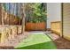 Landscaped backyard with a wooden fence and a view of the trees at 11894 Aspen Forest Dr, Johns Creek, GA 30005