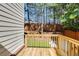 Wooden deck and lush backyard with a wooden privacy fence at 11894 Aspen Forest Dr, Johns Creek, GA 30005