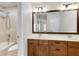 Modern bathroom featuring a double vanity, tile shower, and bright lighting at 11894 Aspen Forest Dr, Johns Creek, GA 30005