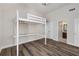 Bright bedroom with a loft bed, hardwood floors, and access to the bathroom at 11894 Aspen Forest Dr, Johns Creek, GA 30005