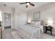A bedroom with a queen bed, two windows, ceiling fan, and neutral decor at 11894 Aspen Forest Dr, Johns Creek, GA 30005