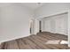 Spacious bedroom featuring hardwood floors, a high ceiling, and access to the bathroom at 11894 Aspen Forest Dr, Johns Creek, GA 30005