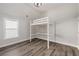 A bedroom featuring a loft bed, hardwood floors and a big window at 11894 Aspen Forest Dr, Johns Creek, GA 30005