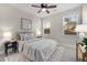 A bedroom with a queen bed, two windows, ceiling fan, and neutral decor at 11894 Aspen Forest Dr, Johns Creek, GA 30005