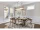 Bright dining room with modern chandelier, neutral tones, and views of the outdoors at 11894 Aspen Forest Dr, Johns Creek, GA 30005