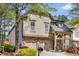 Charming two-story home featuring a stone facade, attached two-car garage, and landscaped front yard at 11894 Aspen Forest Dr, Johns Creek, GA 30005