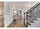 Elegant foyer with hardwood floors, staircase, and wainscoting, leading to a spacious living area at 11894 Aspen Forest Dr, Johns Creek, GA 30005