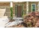 Inviting front entrance featuring a stylish door, stone accents, and manicured landscaping at 11894 Aspen Forest Dr, Johns Creek, GA 30005