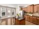 A kitchen with wood cabinets, stainless appliances, granite countertops, and island at 11894 Aspen Forest Dr, Johns Creek, GA 30005
