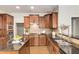 A kitchen with wood cabinets, stainless appliances, granite countertops, and island at 11894 Aspen Forest Dr, Johns Creek, GA 30005