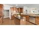 A kitchen with wood cabinets, stainless appliances, granite countertops, and island at 11894 Aspen Forest Dr, Johns Creek, GA 30005