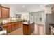 A kitchen with wood cabinets, stainless appliances, granite countertops, and island at 11894 Aspen Forest Dr, Johns Creek, GA 30005