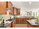 The kitchen features wooden cabinets, granite counters, and an island at 11894 Aspen Forest Dr, Johns Creek, GA 30005