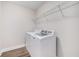 Laundry room with washer, dryer, and wire shelving for storage at 11894 Aspen Forest Dr, Johns Creek, GA 30005