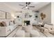 Cozy living room with built-in bookshelves, fireplace, ceiling fan, and stylish decor at 11894 Aspen Forest Dr, Johns Creek, GA 30005
