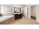 Spacious main bathroom features soaking tub and elegant vanity with dark wood at 11894 Aspen Forest Dr, Johns Creek, GA 30005