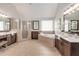 Luxurious primary bath with a double vanity, soaking tub, and glass shower at 11894 Aspen Forest Dr, Johns Creek, GA 30005