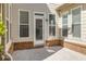Covered outdoor patio with neutral siding and a brick base at 11894 Aspen Forest Dr, Johns Creek, GA 30005