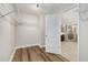 Walk-in closet with ample storage shelves and hardwood floors at 11894 Aspen Forest Dr, Johns Creek, GA 30005